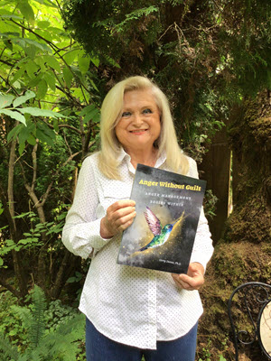 Gerry Dunne holding her book Anger Without Guilt